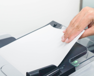 Image of a document being scanned to reduce office paper waste